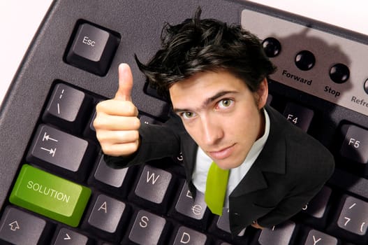 Businessman in a computer keyboard with the word solution in green