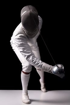 Male fencer isolated in a dark background