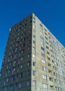 Skyscraper in sunlight towards blue sky