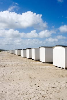 Row of White boathouses on the beach