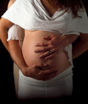 Pregnant couple holding their hands