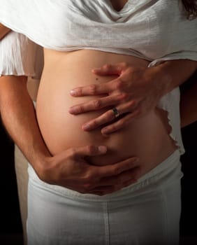 Pregnant couple holding their hands