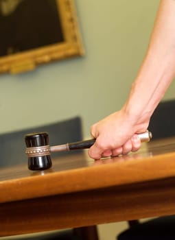 Hand Holding a Mallet on a table