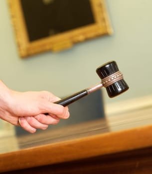 Hand Holding a Mallet on a table