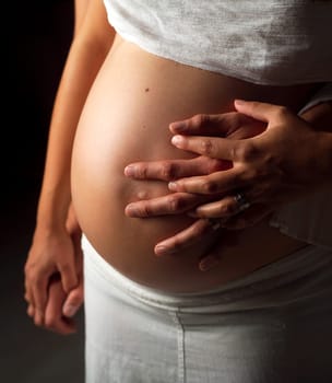 Pregnant couple holding their hands