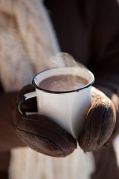 Mug of hot chocolate outdoors on a winter day