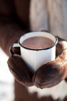 Mug of hot chocolate outdoors on a winter day
