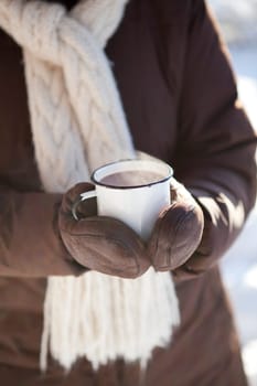Mug of hot chocolate outdoors on a winter day