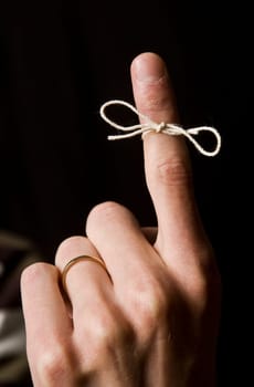 Reminder on the finger isolated on Black background