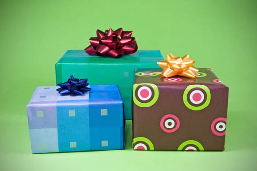 three colorful gifts on the green background