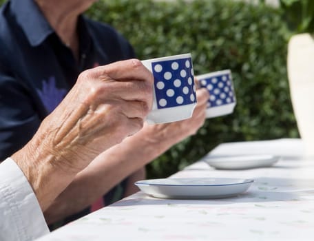 Unreconizable Older women drinking coffee
