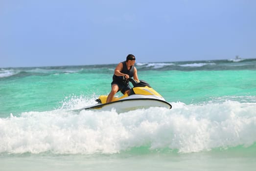 Man on Wave Runner turns fast on the water
