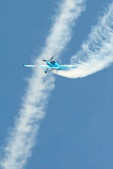 Blades aerobatic display pilot crossing the vapor trail of another aircraft during the Farnborough Airshow, Hampshire, UK - July 19, 2010