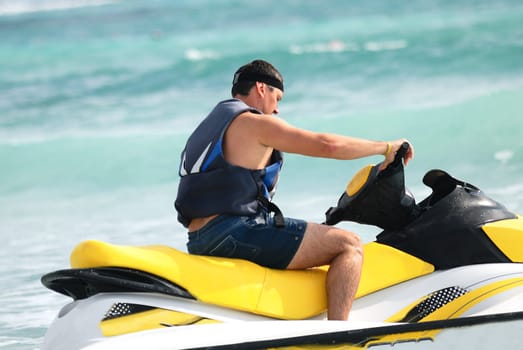 Man on Wave Runner turns fast on the water