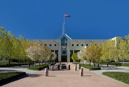 Parliament House in Australian capital city Canberra, waving flag