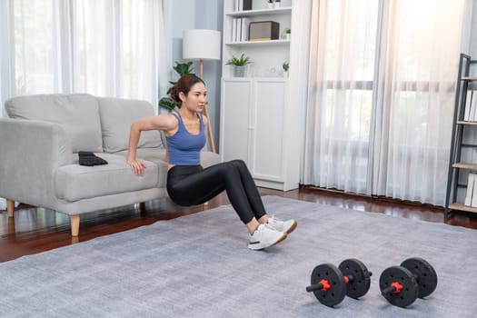 Energetic and determination asian woman push up on sofa for effective chest targeting muscle gain. Pursuit of fit physique and commitment to healthy lifestyle at home. Vigorous