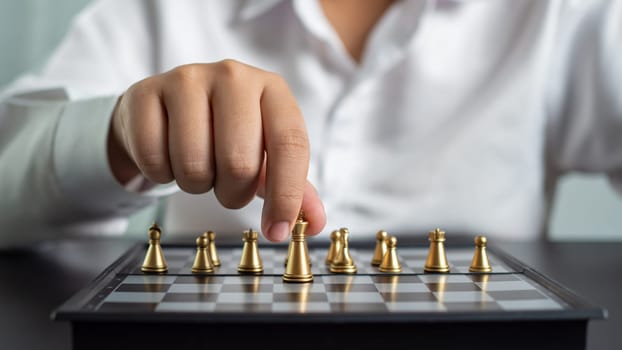 Businessman holding a king on a chess board to move forward and start the game represents Strategic planning and business planning