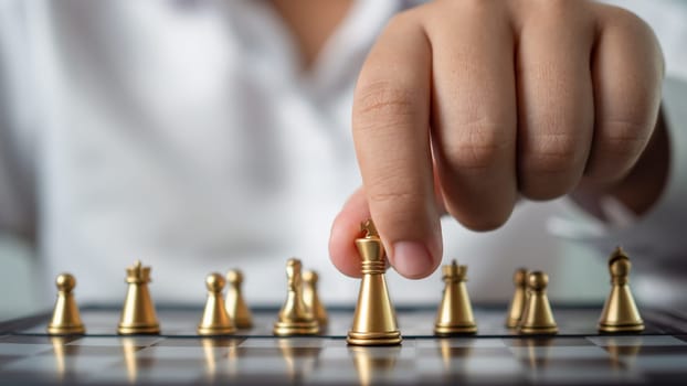 Businessman holding a king on a chess board to move forward and start the game represents Strategic planning and business planning