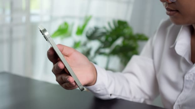 Asian woman holding a smartphone showing communication technology concept