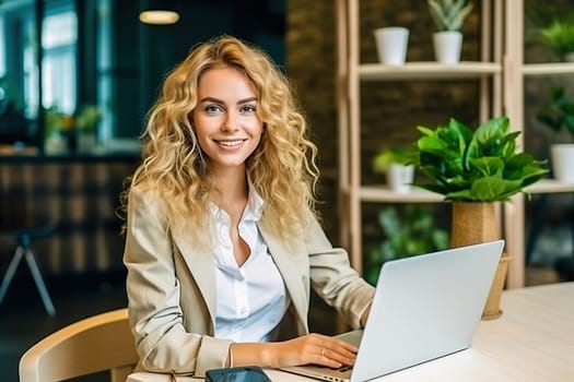 A blonde woman in a formal suit works at a laptop. High quality photo