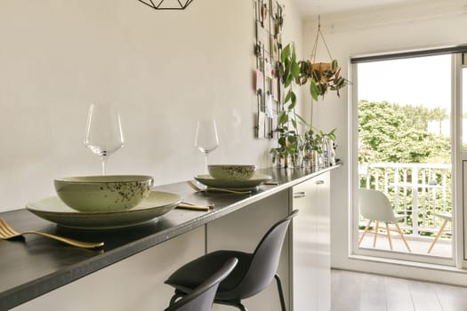 a dining table and chairs in a room with sliding glass doors that open onto the balcony overlooking out to the garden