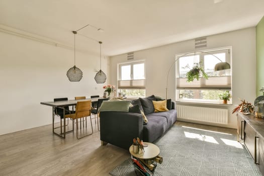 a living room with a couch, coffee table and television set in the corner on the wall is painted white