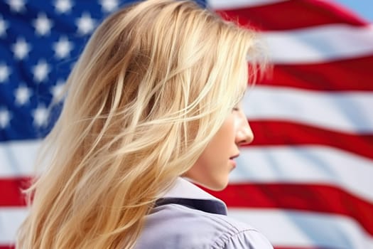 Blonde girl against the background of a blurred US flag.