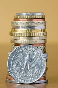 coins stack with quarter dollar in a front