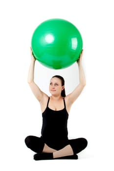 Pregnant woman excercises with gymnastic ball.