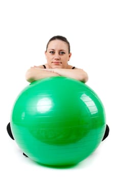Pregnant woman excercises with gymnastic ball.