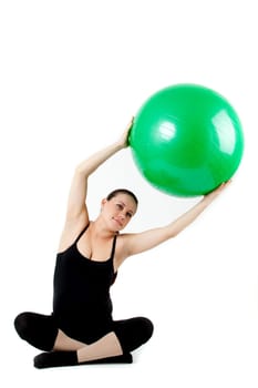 Pregnant woman excercises with gymnastic ball.