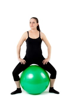 Pregnant woman excercises with gymnastic ball.