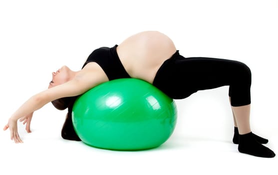 Pregnant woman excercises with gymnastic ball.