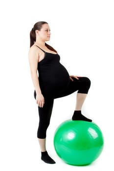 Pregnant woman excercises with gymnastic ball.