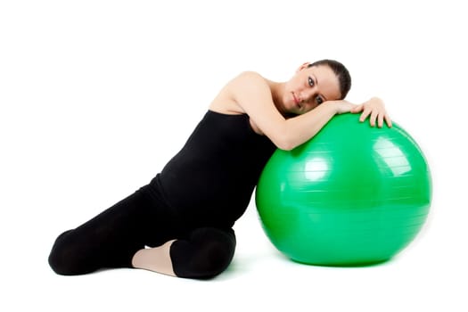 Pregnant woman excercises with gymnastic ball.