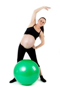 Beautiful pregnant woman sitting with exercise bal. Isolated on white background
