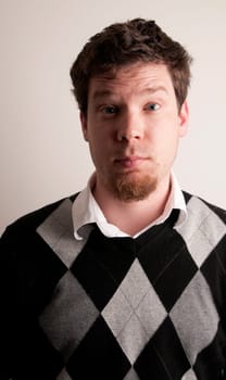 Portrait of Male in an argyle sweater.