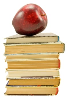 books with red apple over white background