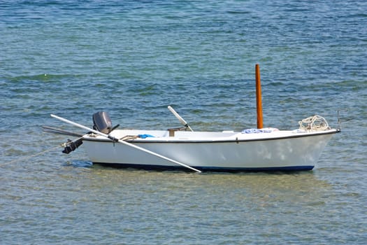 Lonely wooden fishing rowboat on the sea