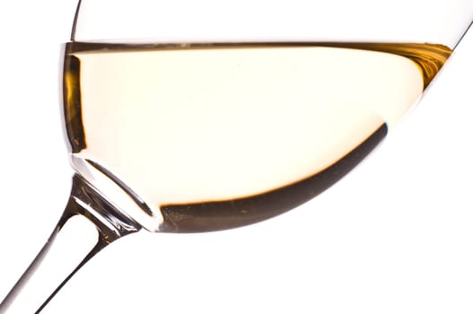 A wine glass with white wine backlit as a close-up