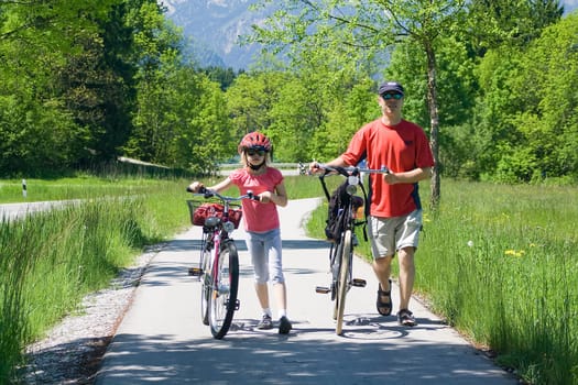 a family havig a weekend excursion on their bikes