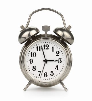 Silver plated old alarm clock, isolated on white background