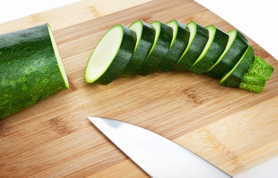 Sliced zucchini on a wooden cutting board
