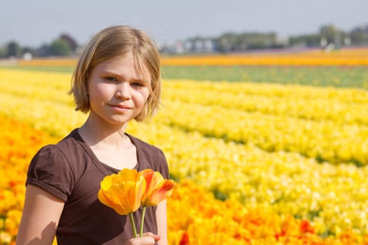little girl in tulips field
