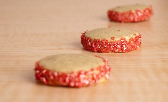Three Pomegranate Cookies on Wooden Table.