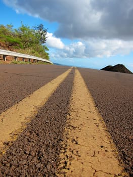 brown dusty road with yellow lines on Hawaii