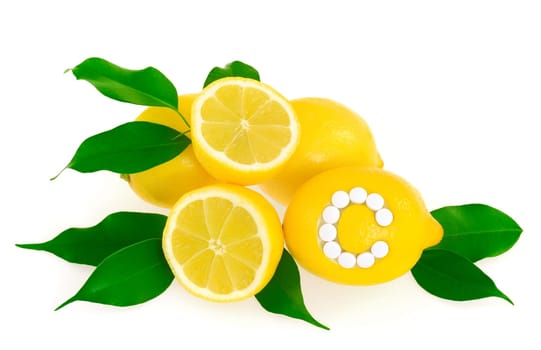 Lemons with vitamin c pills over white background - concept