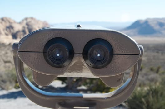 binoculars with beautiful landscape in the background