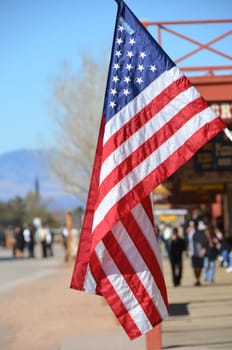 US flag with street scene in the background