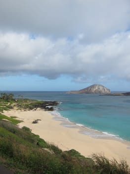 hawaiian coast with cloudy sky and beach